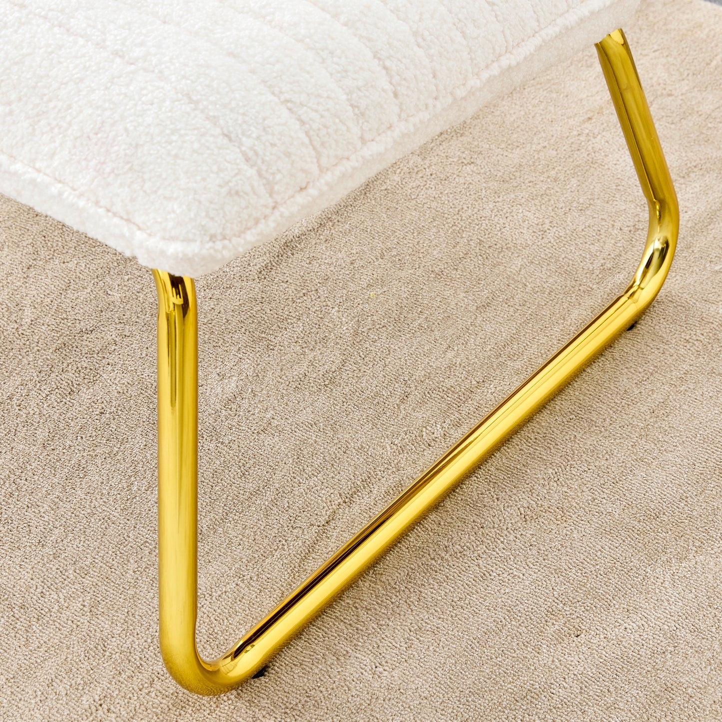 One White minimalist armless sofa chair with plush cushion and backrest paired with golden metal legs