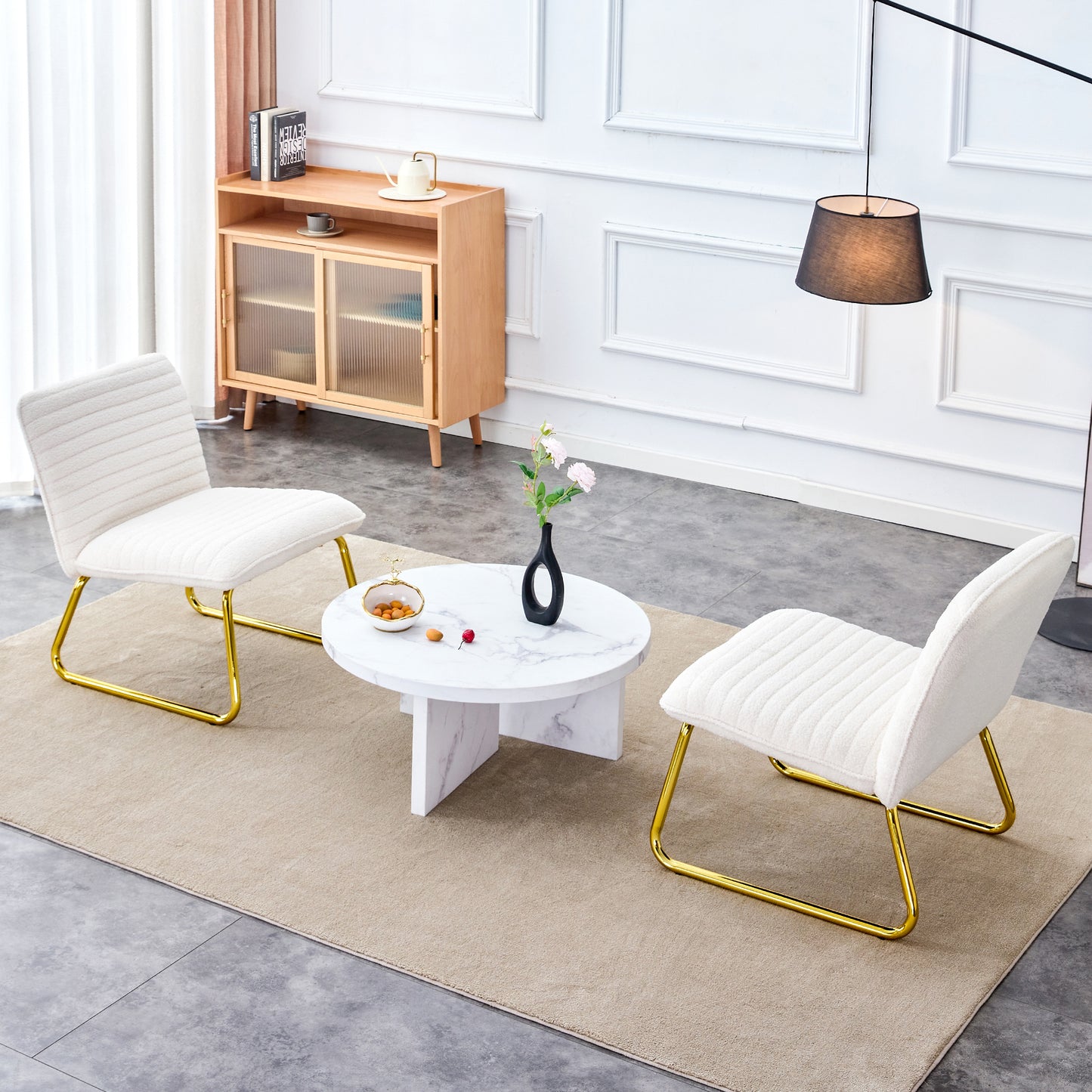 One White minimalist armless sofa chair with plush cushion and backrest paired with golden metal legs