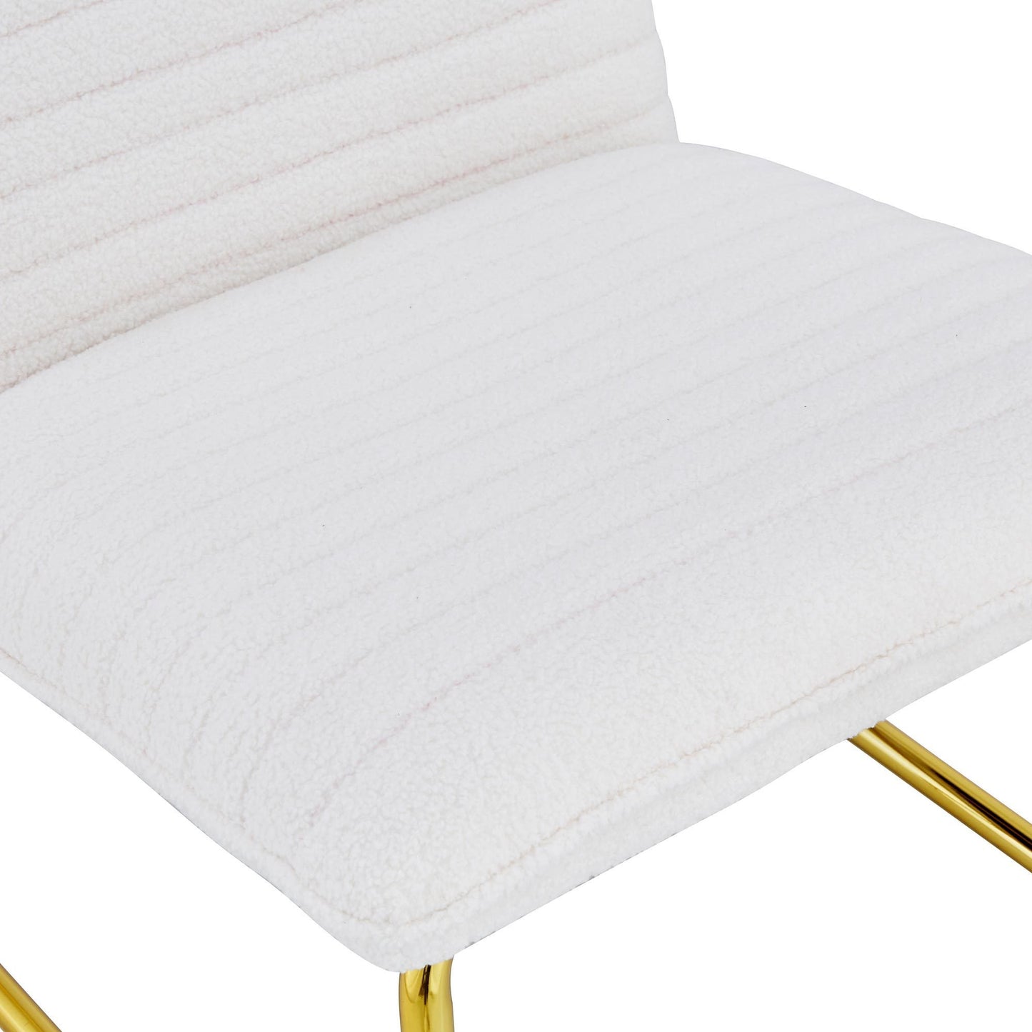 One White minimalist armless sofa chair with plush cushion and backrest paired with golden metal legs