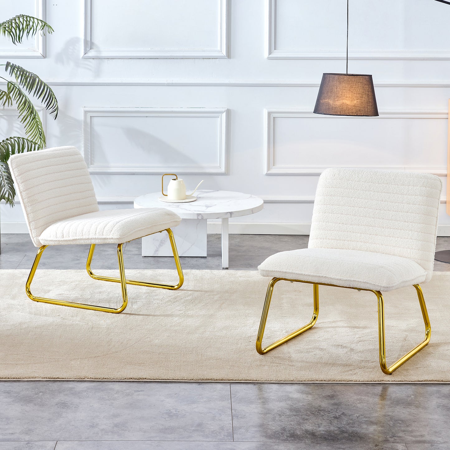 One White minimalist armless sofa chair with plush cushion and backrest paired with golden metal legs